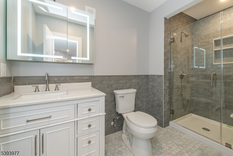 41 Elmwood Avenue, Unit 1 Montclair, NJ 07042 - Photo 9 of 18 a bathroom with a sink a toilet and a mirror