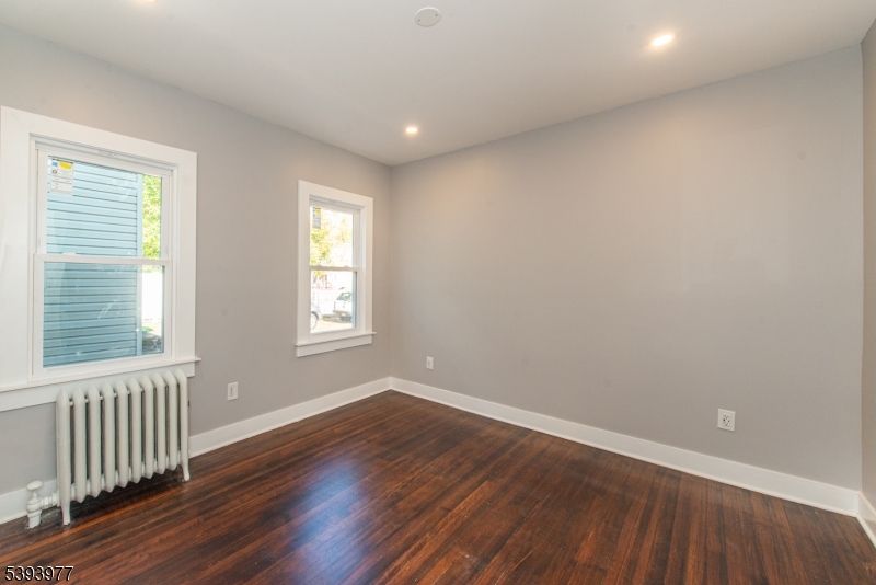 41 Elmwood Avenue, Unit 1 Montclair, NJ 07042 - Photo 10 of 18 a view of an empty room with wooden floor and a window