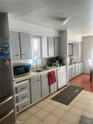 a kitchen with a stove top oven and cabinets