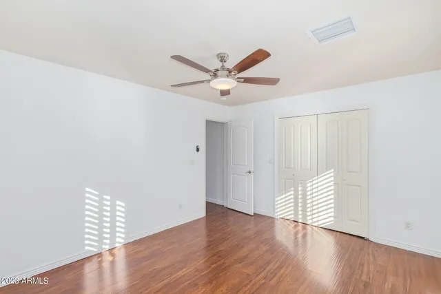 a view of an empty room with wooden floor
