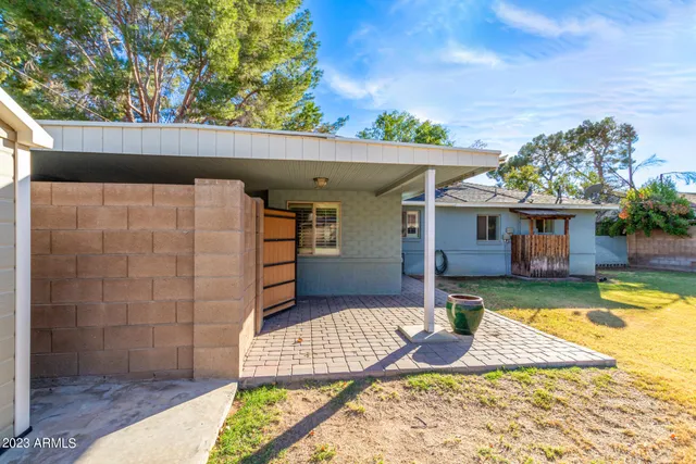a view of a house with swimming pool next to a yard