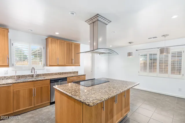 a kitchen with granite countertop a sink and a window