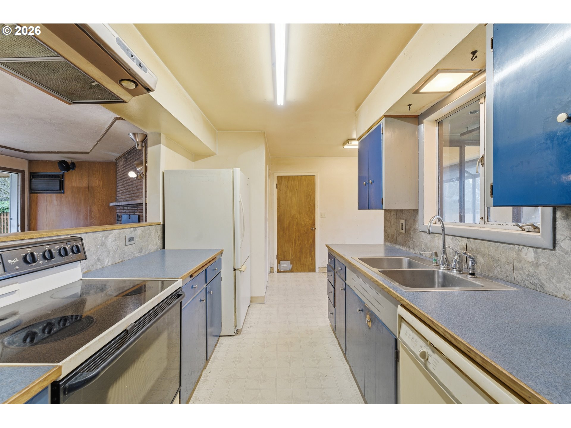 64 Northwest Florence Avenue Gresham, OR 97030 - Photo 13 of 29 a kitchen with a sink stove and cabinets