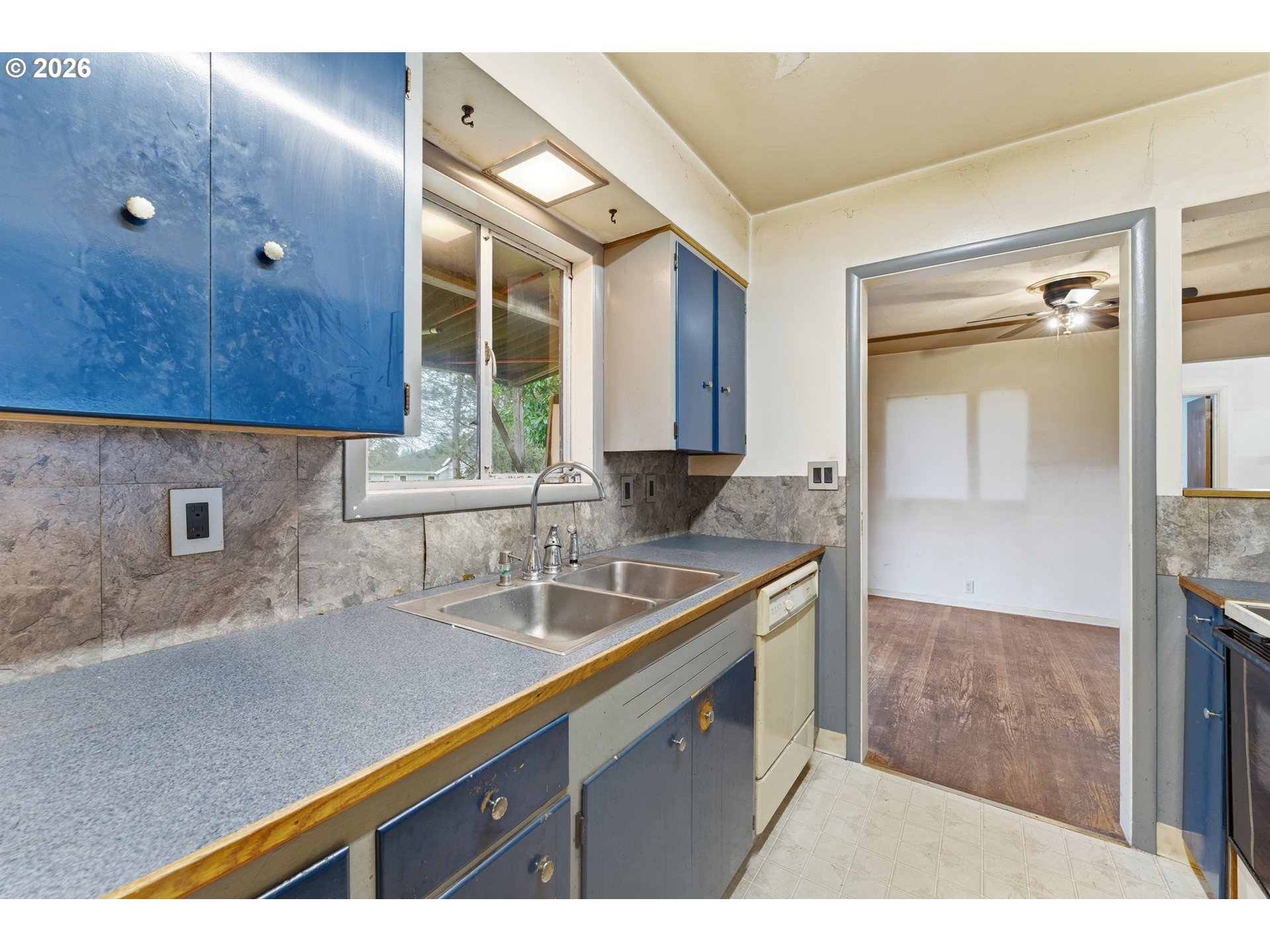 64 Northwest Florence Avenue Gresham, OR 97030 - Photo 14 of 29 a kitchen with a sink and a refrigerator
