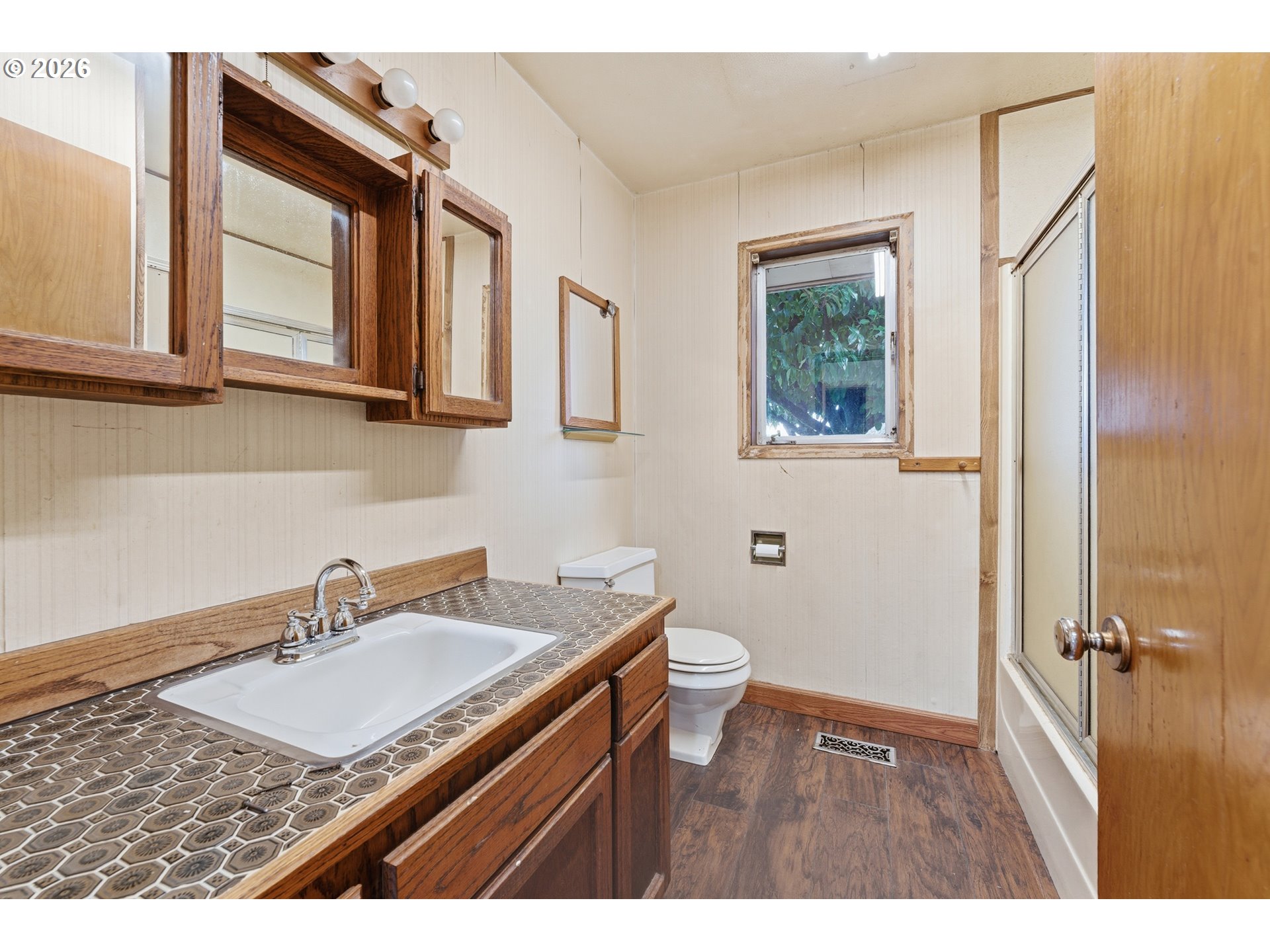 64 Northwest Florence Avenue Gresham, OR 97030 - Photo 24 of 29 a bathroom with a sink a mirror and a toilet