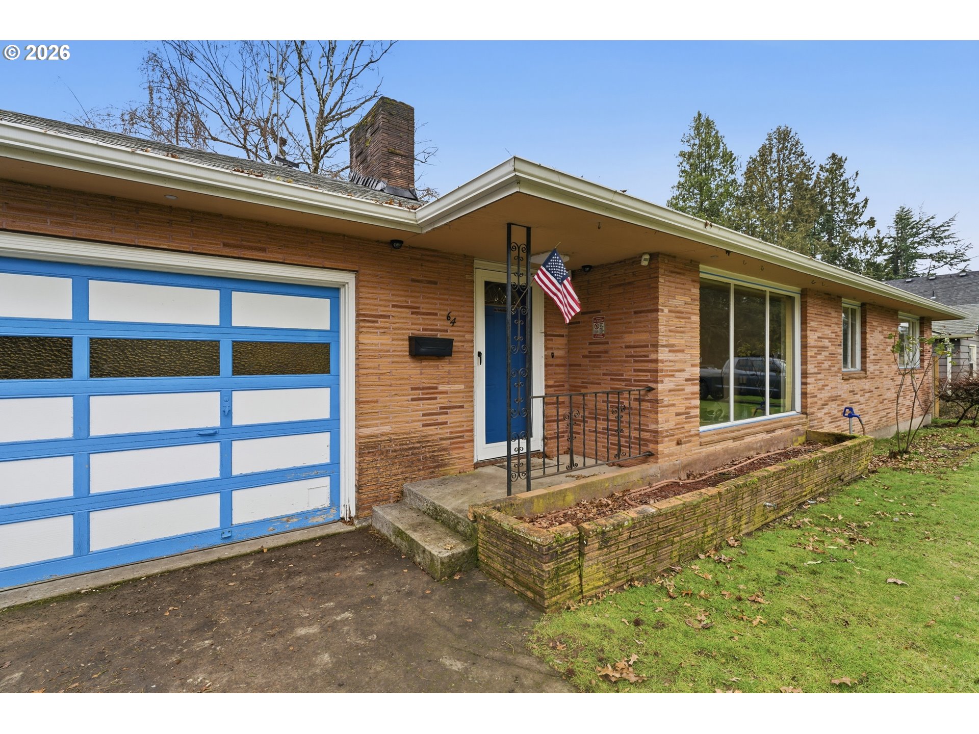 64 Northwest Florence Avenue Gresham, OR 97030 - Photo 4 of 29 a view of a house with a large window and wooden fence