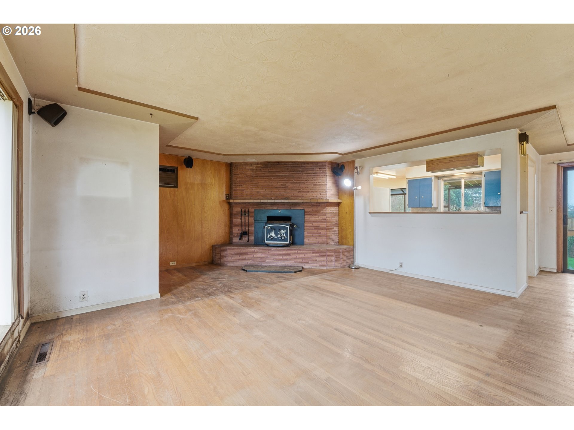 64 Northwest Florence Avenue Gresham, OR 97030 - Photo 6 of 29 a view of empty room with wooden floor and fireplace