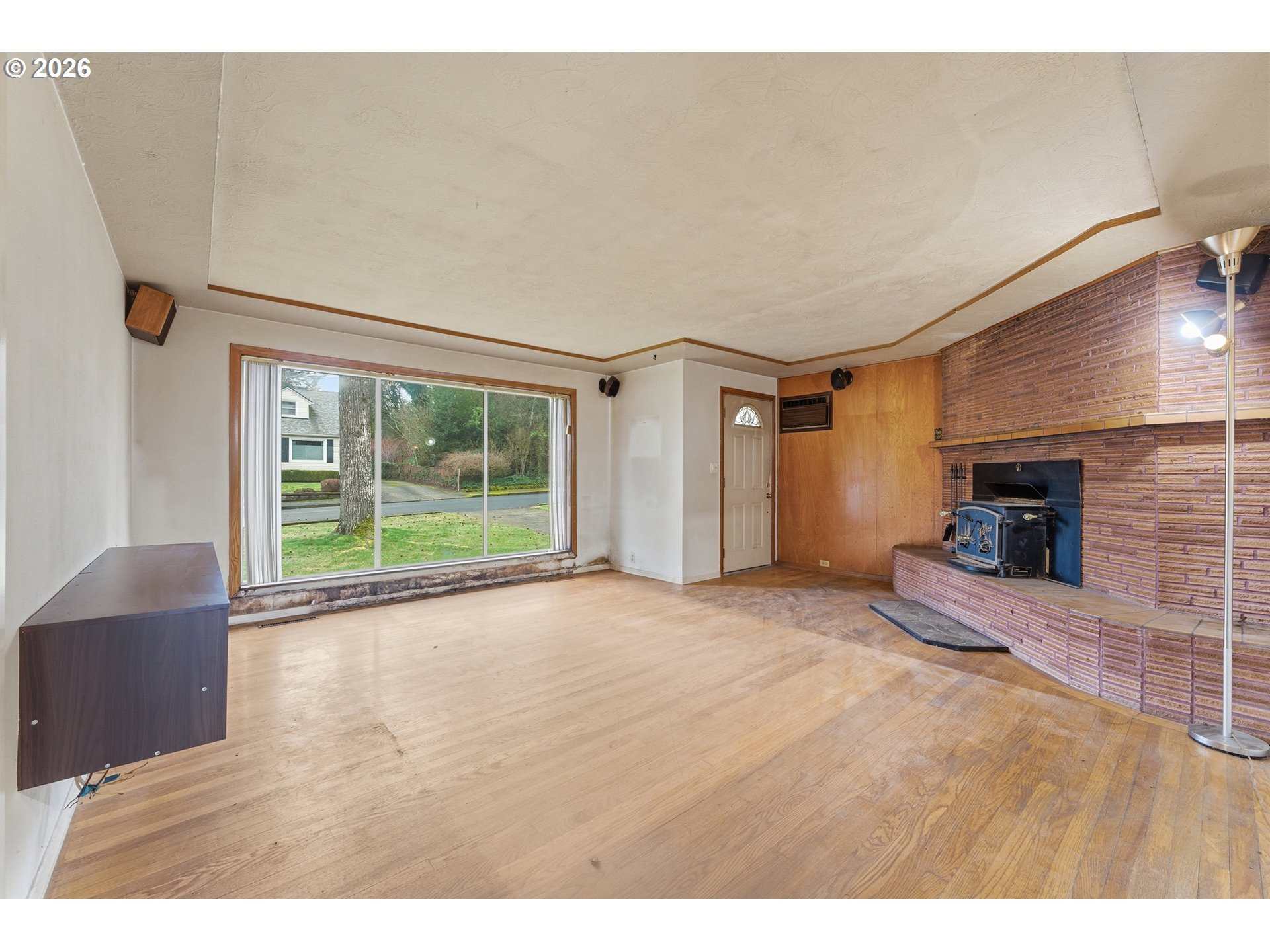 64 Northwest Florence Avenue Gresham, OR 97030 - Photo 7 of 29 a view of an empty room with a fireplace and a window
