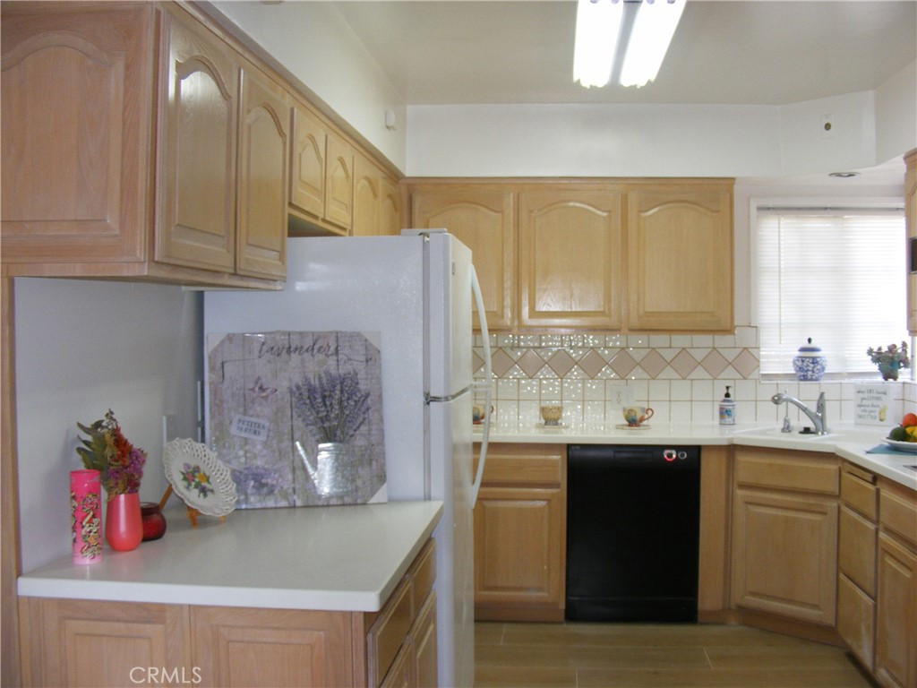 13218 McKinley Avenue Chino, CA 91710 - Photo 13 of 14 a kitchen with stainless steel appliances granite countertop a sink dishwasher stove and cabinets