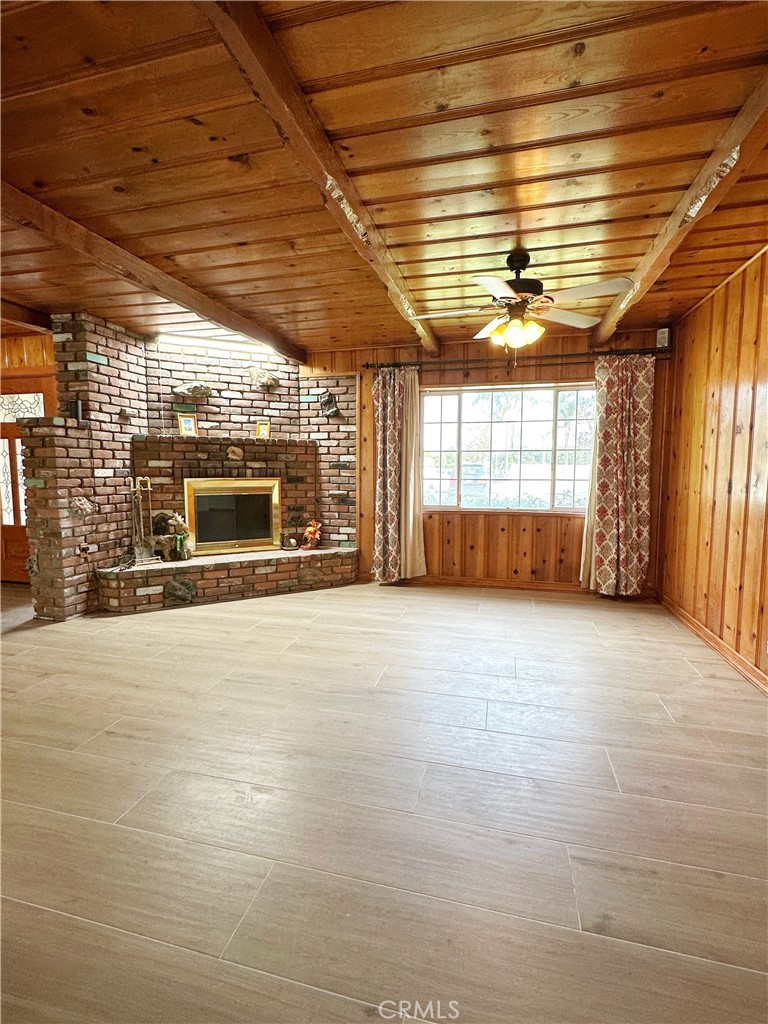 13218 McKinley Avenue Chino, CA 91710 - Photo 3 of 14 a view of an empty room with a fireplace and a window