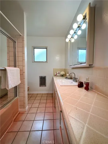 a large bathroom with a sink a large mirror and a shower