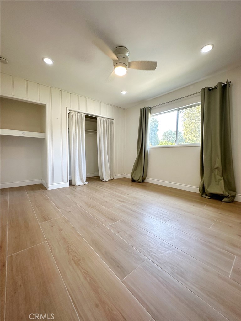 13218 McKinley Avenue Chino, CA 91710 - Photo 9 of 14 a view of empty room with wooden floor and window