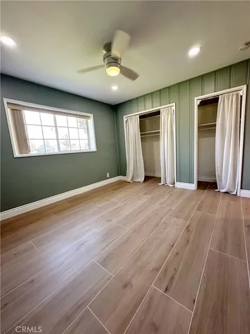 a living room with furniture and a dining table with kitchen view