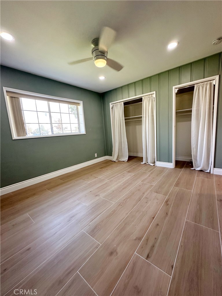 13218 McKinley Avenue Chino, CA 91710 - Photo 10 of 14 an empty room with wooden floor and windows