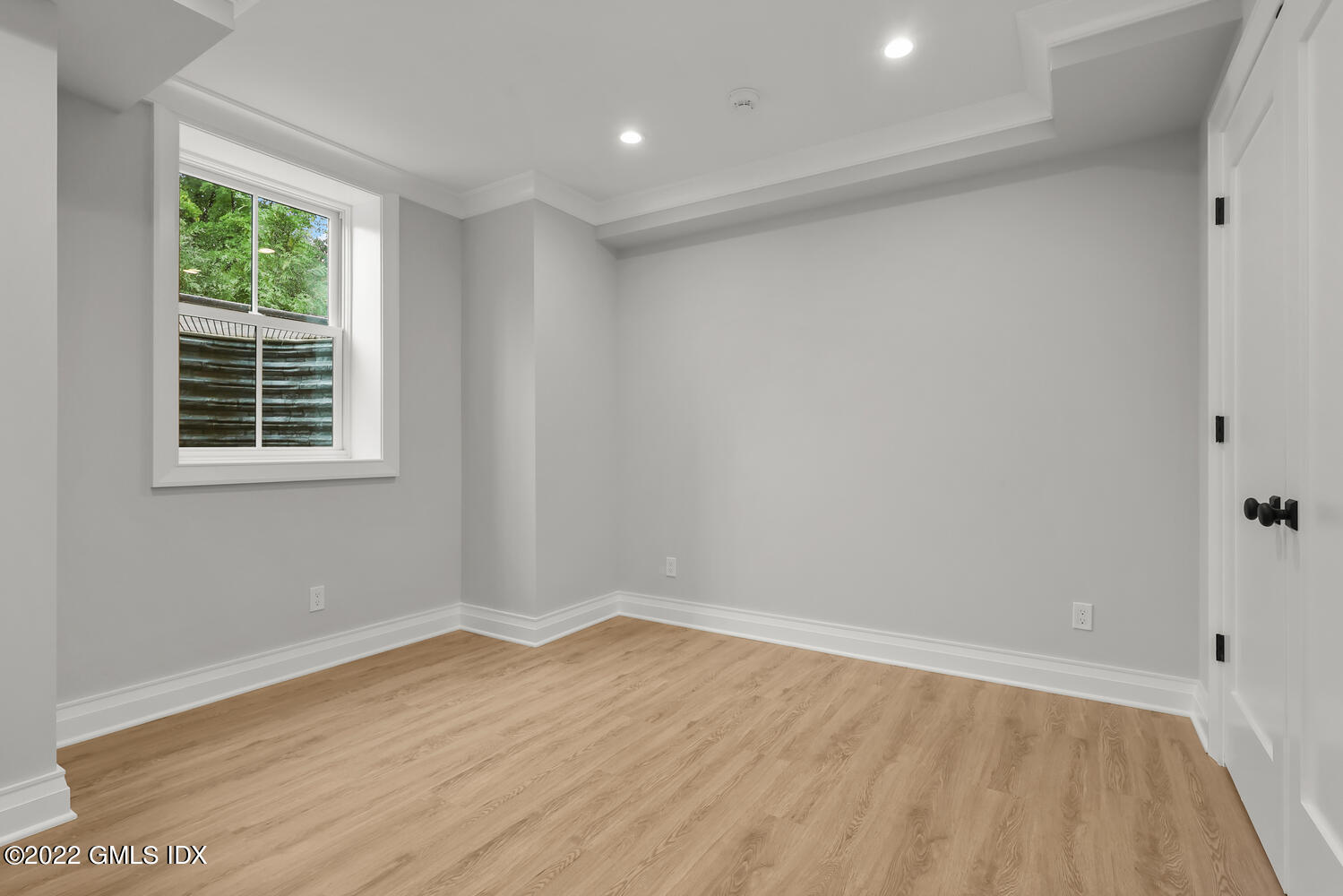 108 Sheephill Road Riverside, CT 06878 - Photo 40 of 47 an empty room with wooden floor and windows