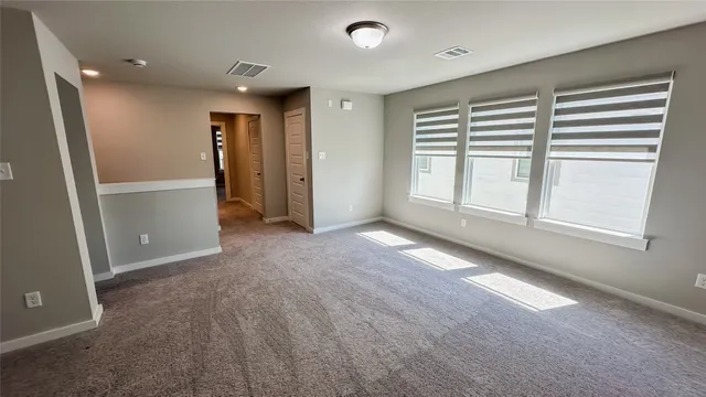 an empty room with windows and closet