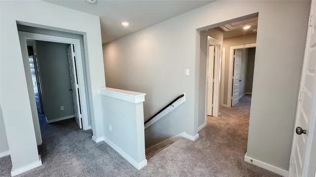 a view of a hallway with closet and a bathroom