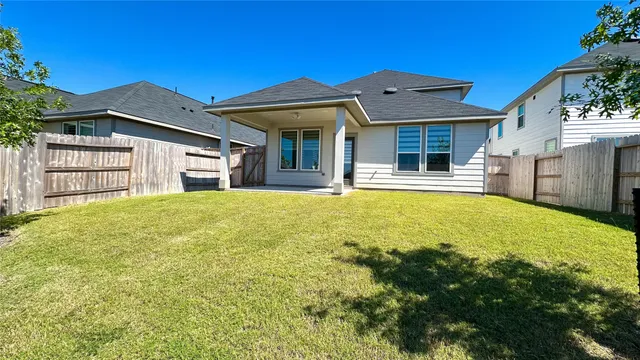 a front view of a house with a garden and yard