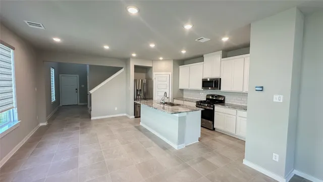 a kitchen with sink and stainless steel appliances
