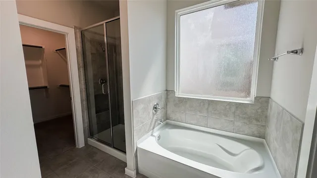 a bathroom with a tub and shower