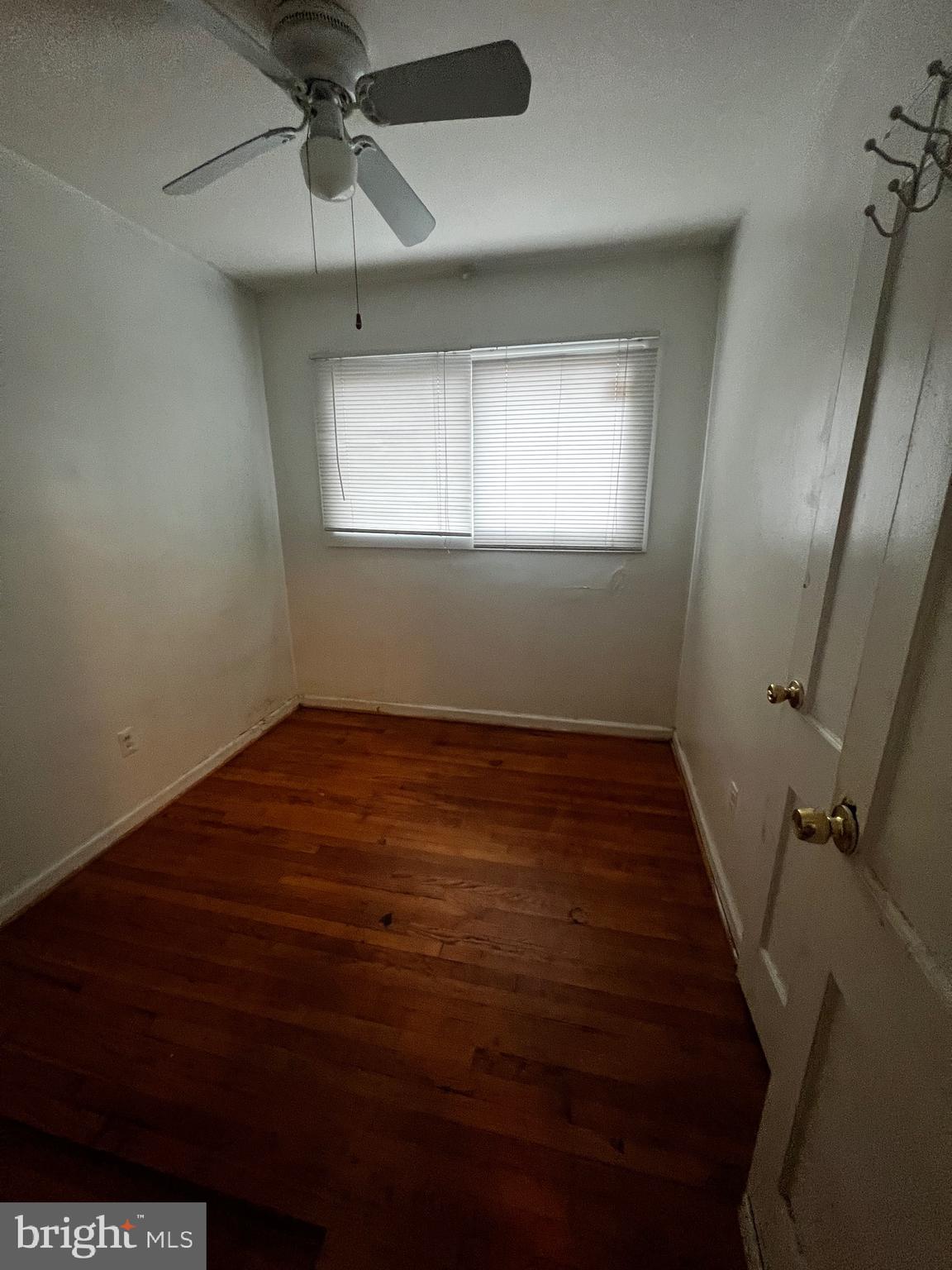 8318 Navahoe Drive Silver Spring, MD 20903 - Photo 5 of 11 an empty room with wooden floor fan and windows