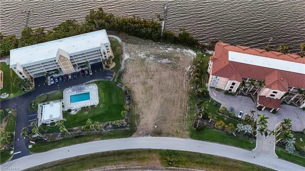 a view of a terrace with lawn chairs