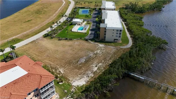 an aerial view of a house with a yard and lake view