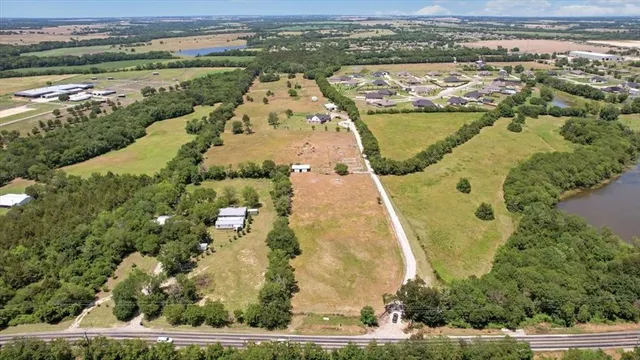 an aerial view of ocean with residential house and lake view