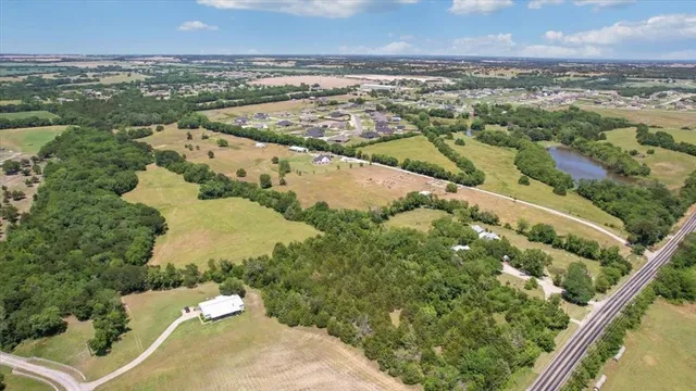 a bathroom with a tub a mirror and a shower
