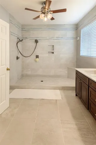 a bedroom with a bed and ceiling fan