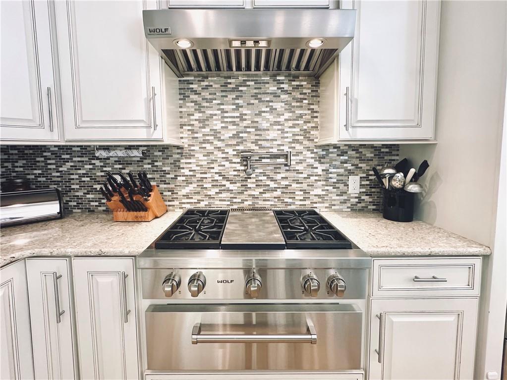 3232 Brookview Road Marietta, GA 30067 - Photo 15 of 86 a kitchen with granite countertop a stove sink and cabinets
