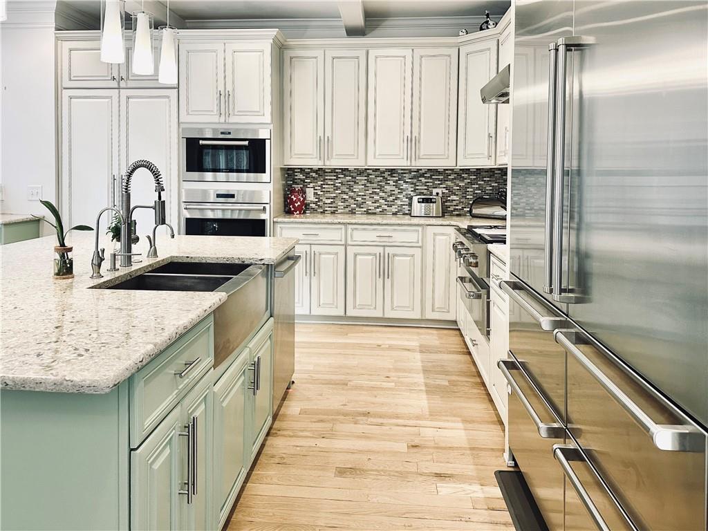 3232 Brookview Road Marietta, GA 30067 - Photo 16 of 86 a kitchen with kitchen island granite countertop a sink appliances cabinets and a counter top space