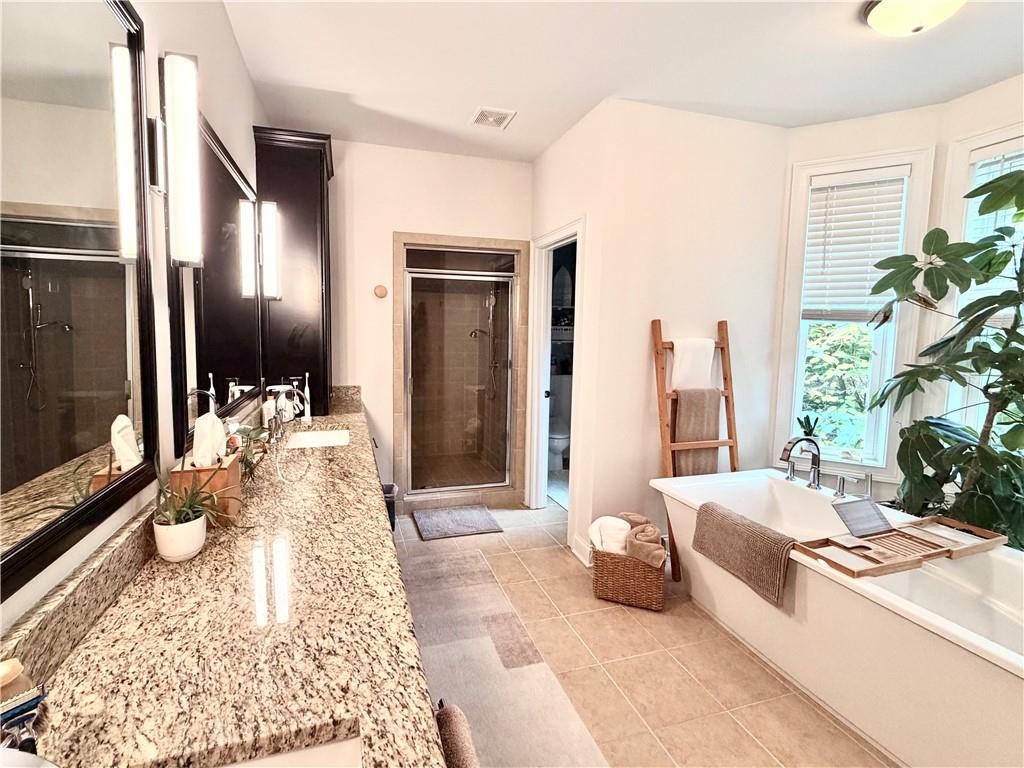 3232 Brookview Road Marietta, GA 30067 - Photo 30 of 86 a spacious bedroom with a large bed and a flat screen tv