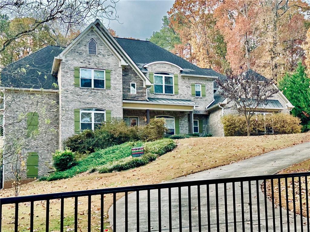3232 Brookview Road Marietta, GA 30067 - Photo 3 of 86 a front view of house with yard and trees around