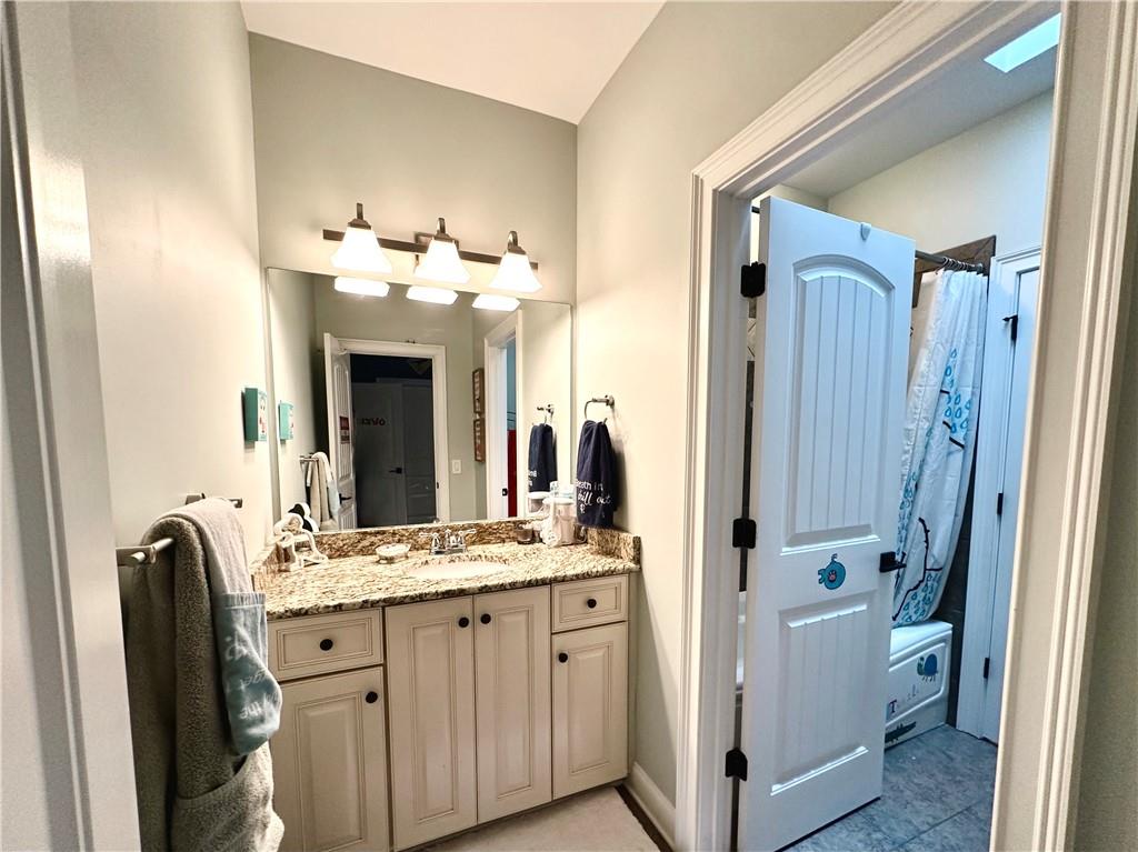3232 Brookview Road Marietta, GA 30067 - Photo 46 of 86 a bathroom with a double vanity sink and a mirror