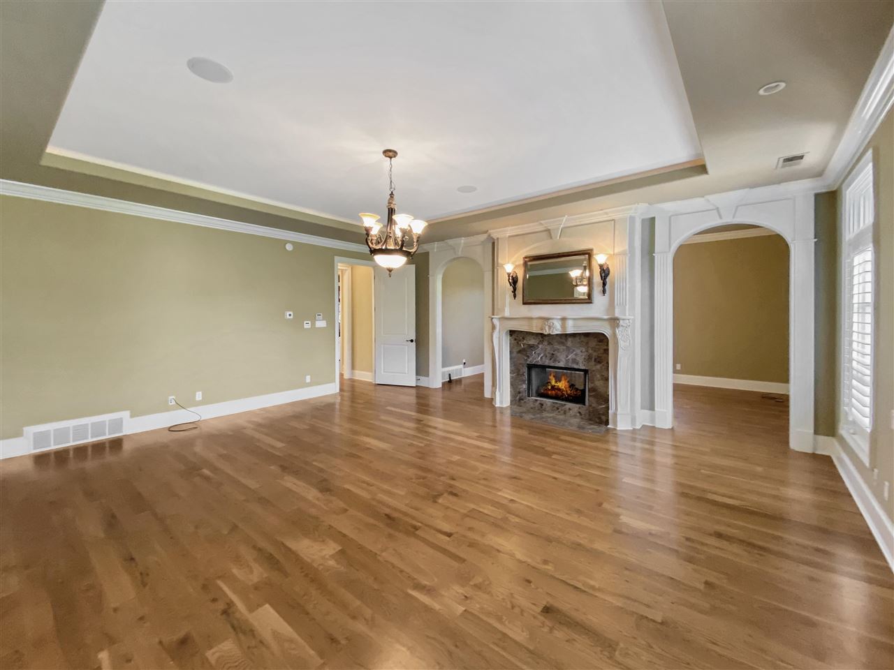 400 Buckland Cove Eads, TN 38028 - Photo 11 of 25 a view of a livingroom with a fireplace a chandelier and wooden floor