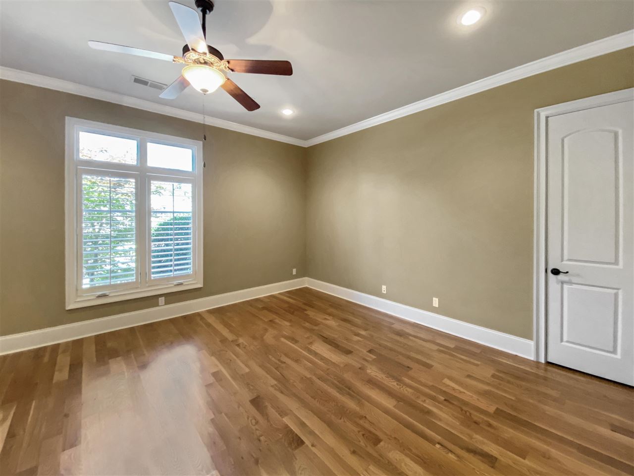 400 Buckland Cove Eads, TN 38028 - Photo 16 of 25 an empty room with wooden floor chandelier fan and windows
