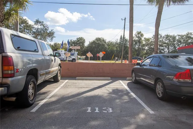 a view of cars parked on the side of a street