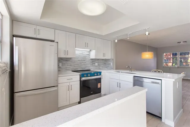 a white refrigerator freezer sitting in a kitchen