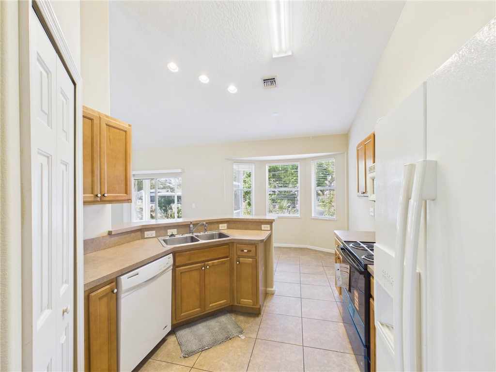462 Lloyd Street Sebastian, FL 32958 - Photo 13 of 28 a kitchen with a stove a refrigerator and a sink