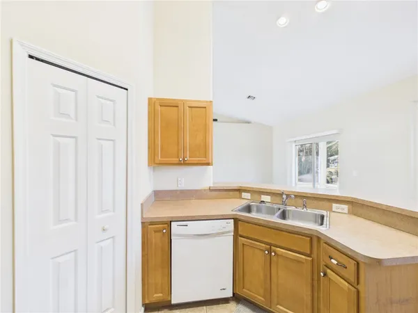 a kitchen with a sink cabinets and a window