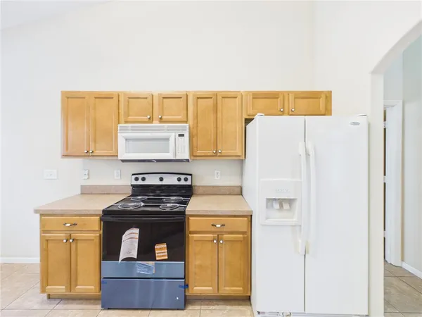 a kitchen with a stove and a refrigerator