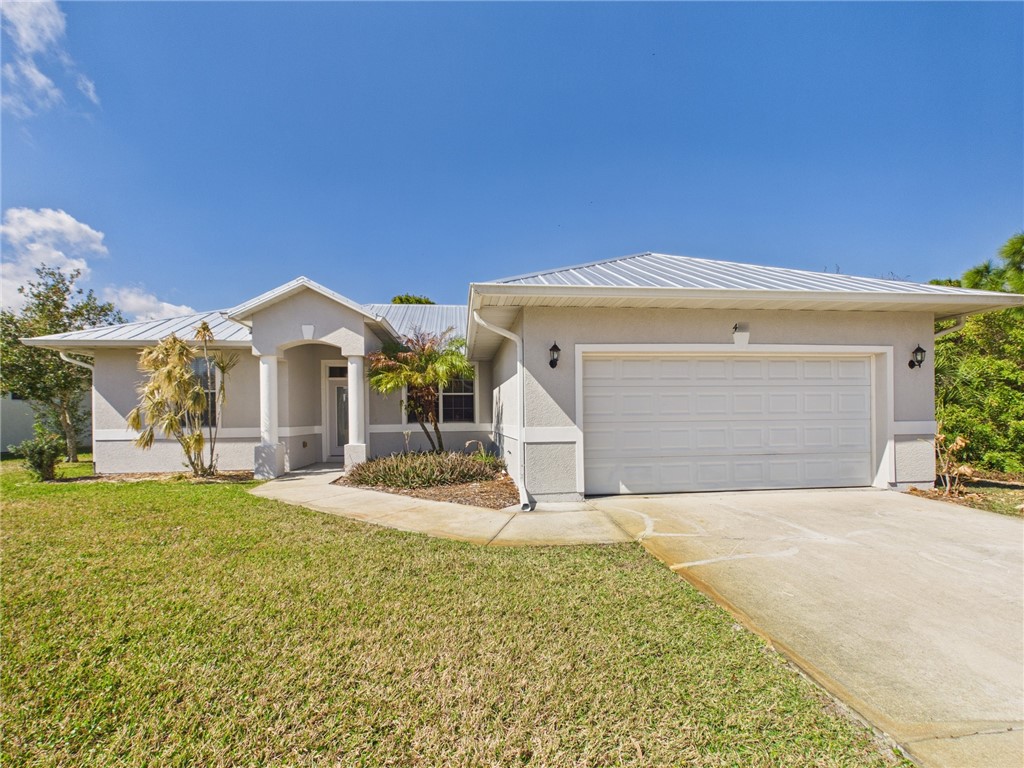 462 Lloyd Street Sebastian, FL 32958 - Photo 2 of 28 a front view of a house with a yard and garage