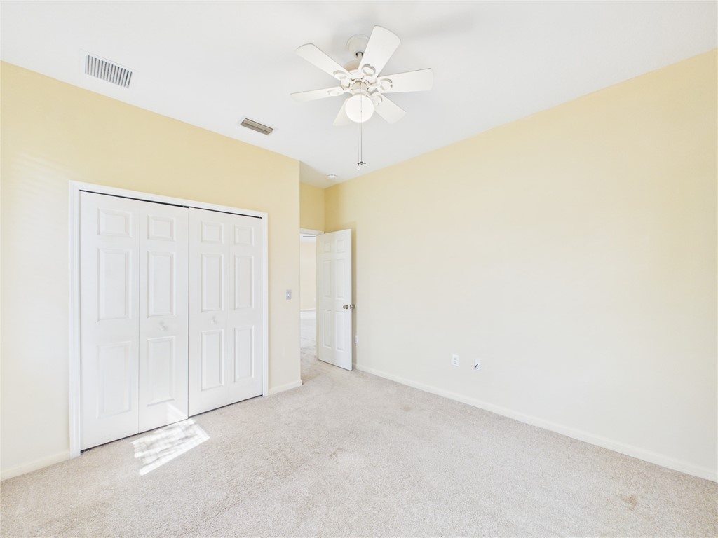 462 Lloyd Street Sebastian, FL 32958 - Photo 23 of 28 an empty room with a ceiling fan and a window