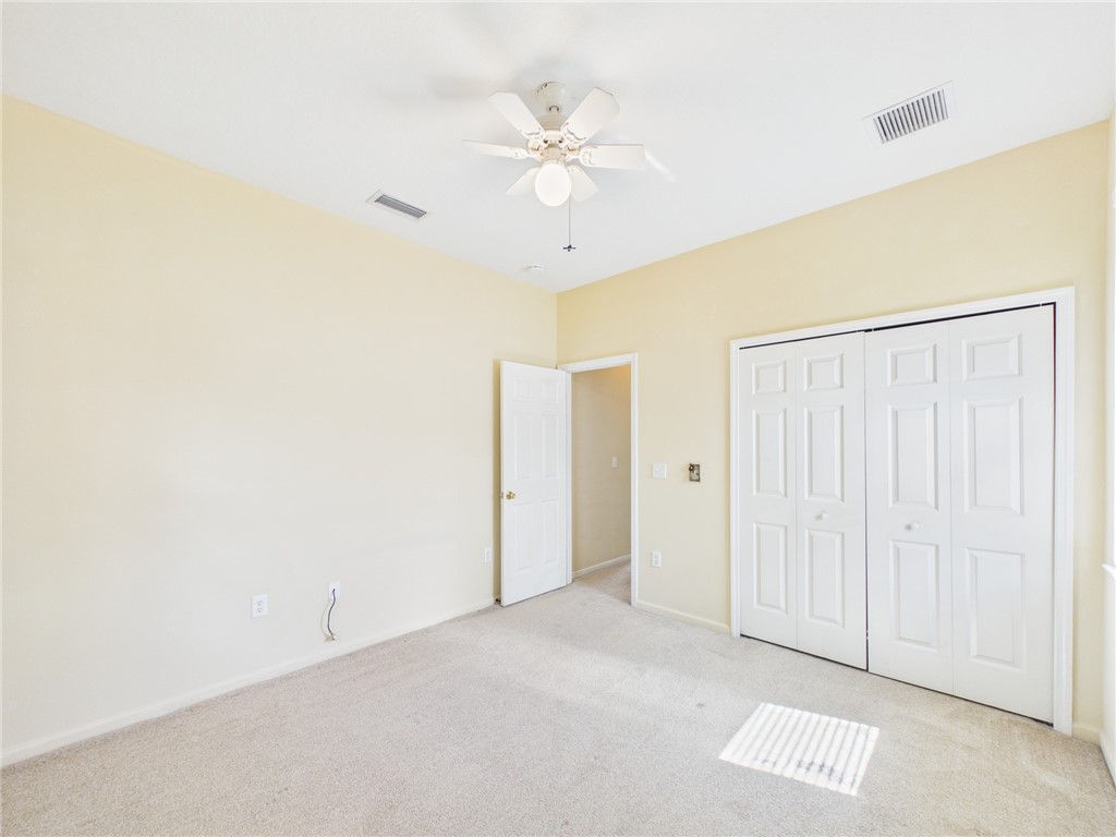 462 Lloyd Street Sebastian, FL 32958 - Photo 26 of 28 an empty room with a ceiling fan and a window