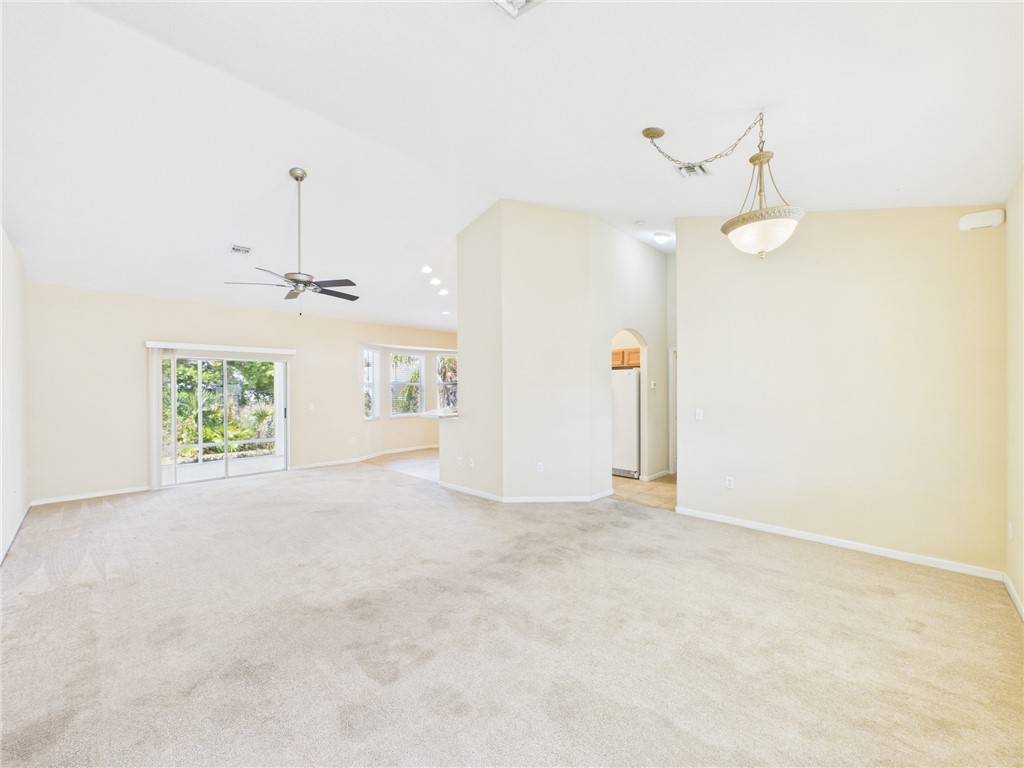 462 Lloyd Street Sebastian, FL 32958 - Photo 3 of 28 en empty room with windows and ceiling fan