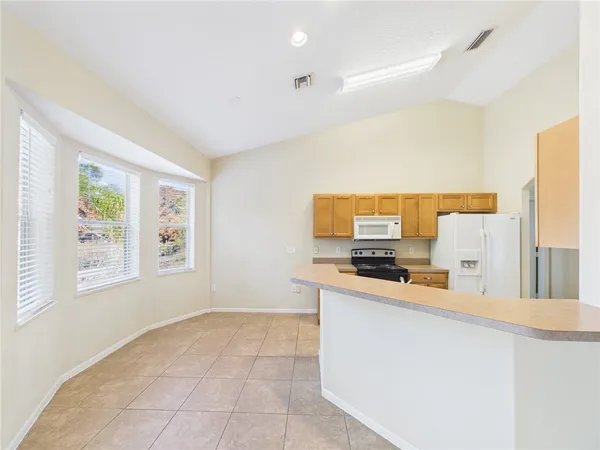 a kitchen with stainless steel appliances granite countertop a sink and a stove