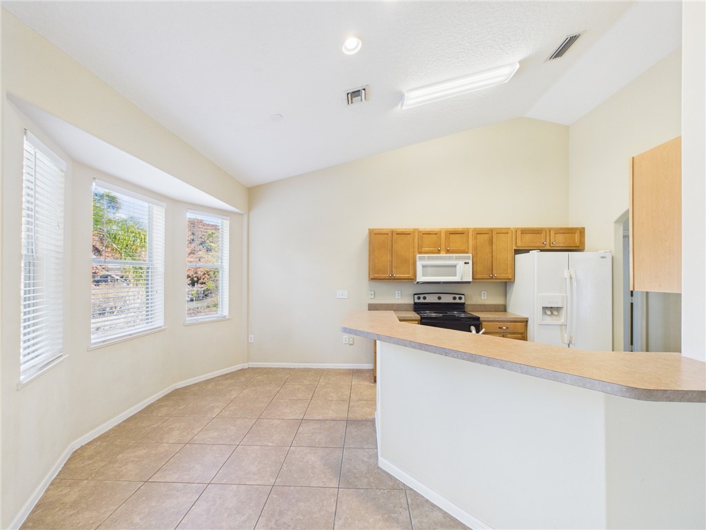 462 Lloyd Street Sebastian, FL 32958 - Photo 9 of 28 a kitchen with stainless steel appliances granite countertop a sink and a stove