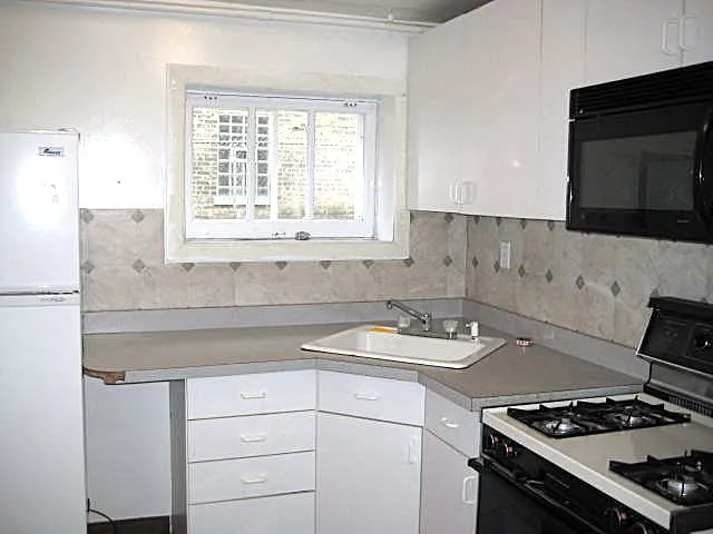 a kitchen with appliances a sink and a stove