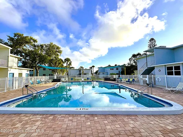a view of a swimming pool with a patio